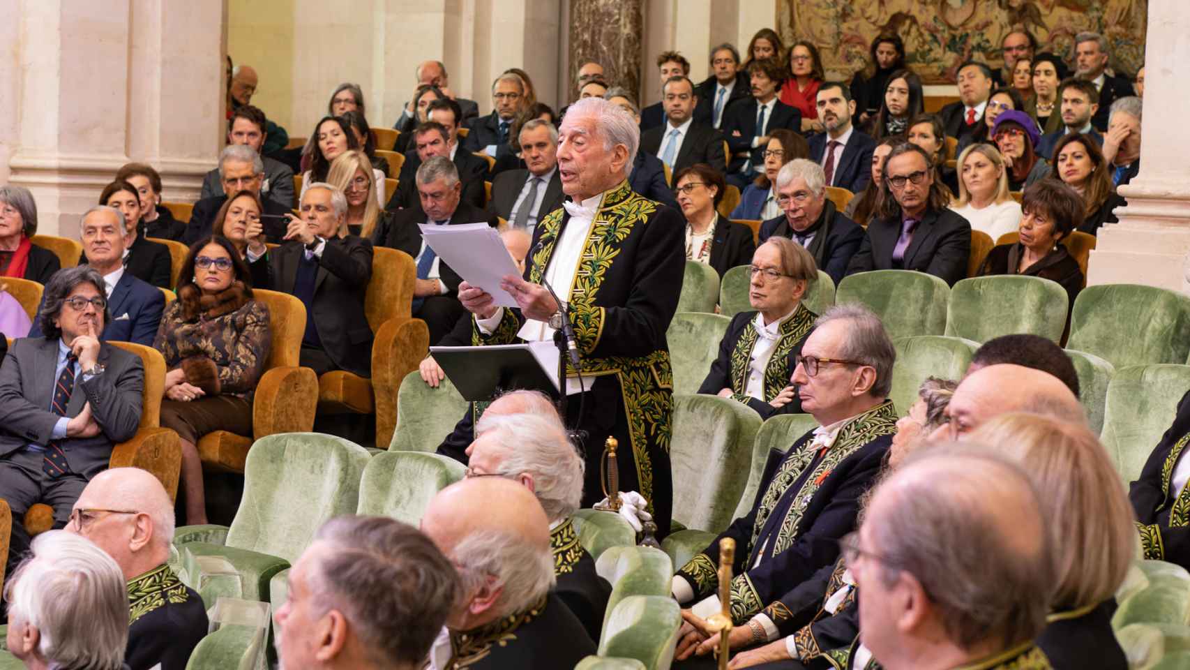 El escritor hispano-peruano Mario Vargas Llosa (de pie) pronuncia su discurso de ingreso en la Academia Francesa.
